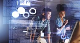 man woman looking at a screen