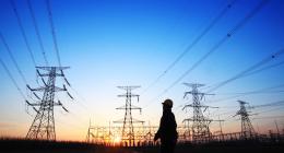 Pylons in the background with a silouhette of a person in the foreground