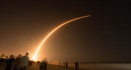 light falling from the sky with a crowd watching