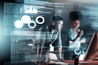 A man and a woman doing data analysis with a holographic screen